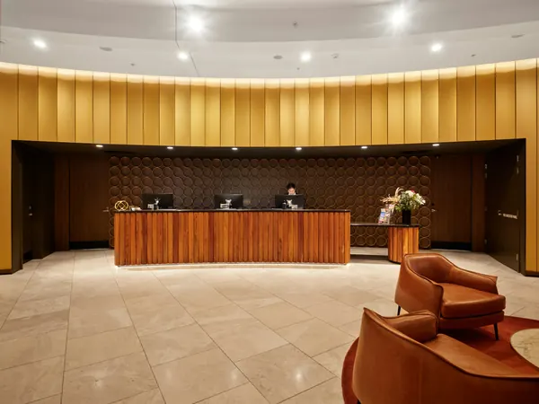 A hotel reception desk in a bright lobby