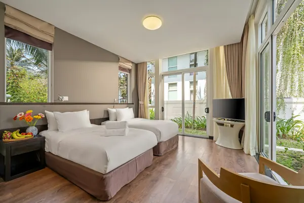 A bright hotel room with two beds