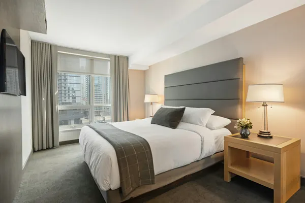 A hotel room with a king bed
