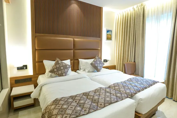 A hotel room with two single beds